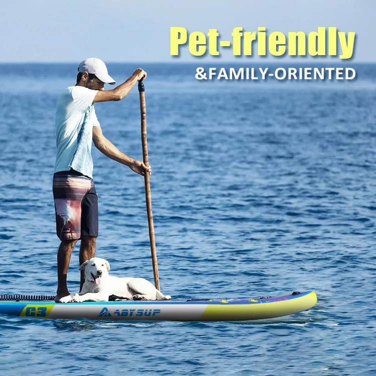 Man paddles on a blue ocean with a dog lying on his paddleboard under clear skies, showcasing a pet-friendly activity.
