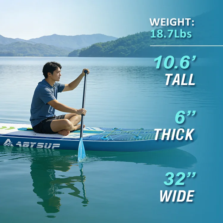 Person seated on a paddleboard on a calm lake with mountains in the background, showcasing paddleboard dimensions and weight.