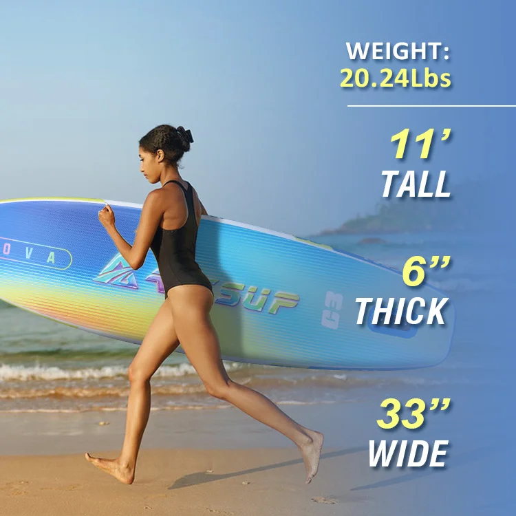 Woman in a swimsuit carrying a colorful paddle board along a sandy beach. Board dimensions: 11' tall, 6' thick, 33' wide, weight 20.24 lbs.