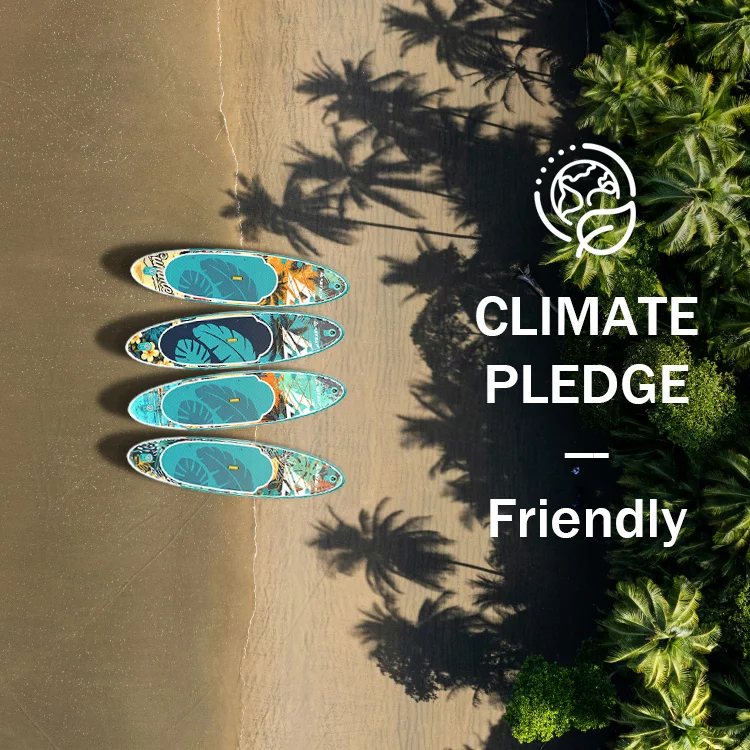 Aerial view of four colorful paddleboards on a sandy tropical beach surrounded by lush green palm trees, with 'Climate Pledge Friendly' text.