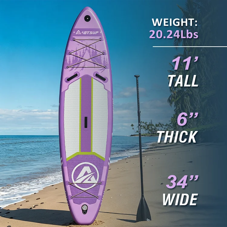 Purple paddleboard with dimensions highlighted, standing upright on a beach with sand, blue skies, and nearby tropical palm trees.